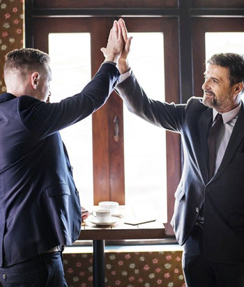 Two business partners giving a high five